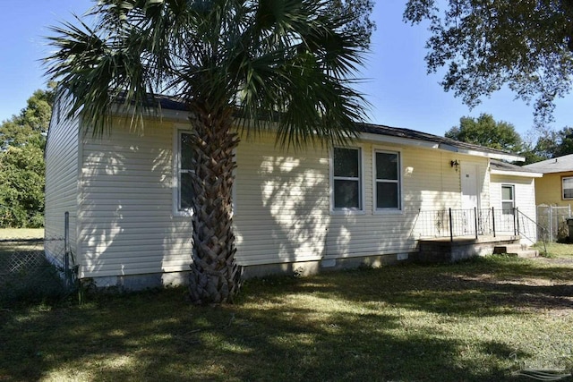 rear view of house with a lawn