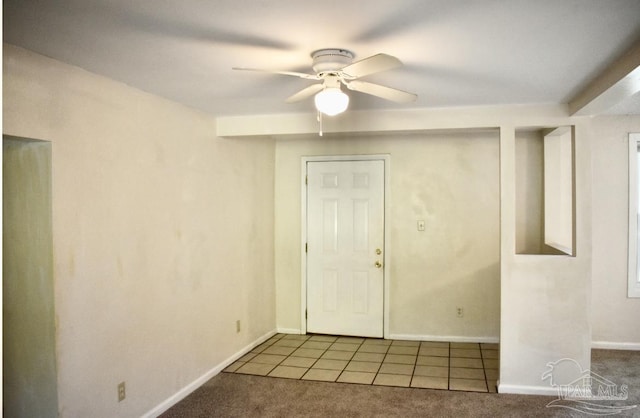 carpeted entrance foyer with ceiling fan