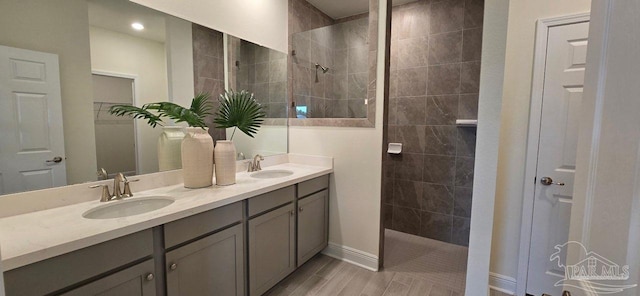5023 Vanerka Dr, Gulf Breeze, FL 32563 - full bathroom featuring a walk in shower, double vanity, and baseboards
