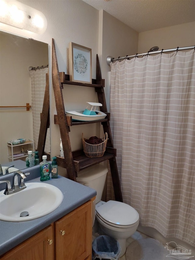 bathroom with vanity, a textured ceiling, and toilet