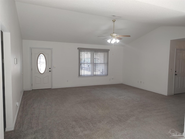 foyer entrance featuring lofted ceiling, carpet floors, and ceiling fan