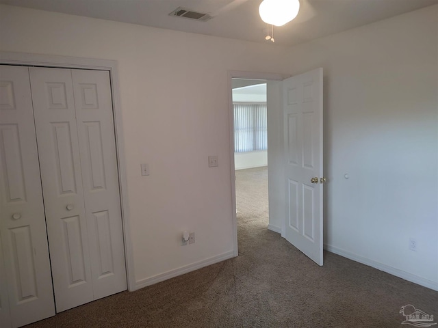 unfurnished bedroom featuring carpet floors and a closet