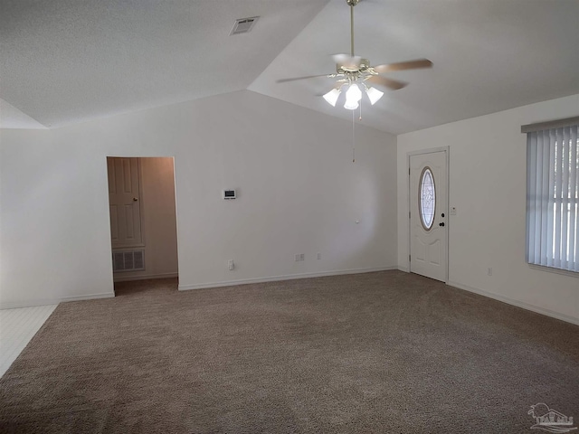 unfurnished living room featuring lofted ceiling, carpet flooring, and ceiling fan