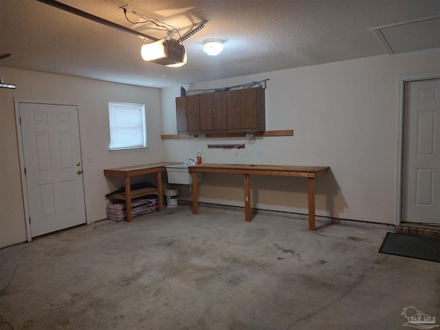 garage with a garage door opener and a workshop area