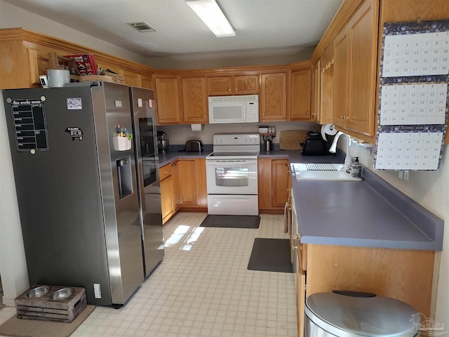 kitchen featuring white appliances and sink