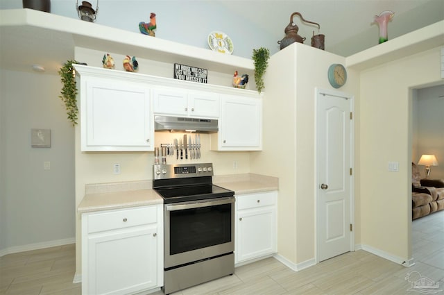 5735 Farrel Way, Milton, FL 32583 - kitchen featuring stainless steel range with electric stovetop, under cabinet range hood, light countertops, and white cabinets