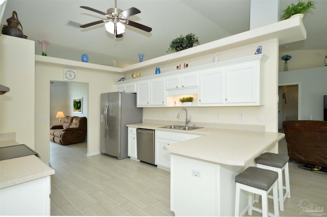 5735 Farrel Way, Milton, FL 32583 - kitchen featuring a sink, appliances with stainless steel finishes, a peninsula, white cabinetry, and ceiling fan