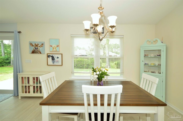 5735 Farrel Way, Milton, FL 32583 - dining room with a chandelier and light wood finished floors