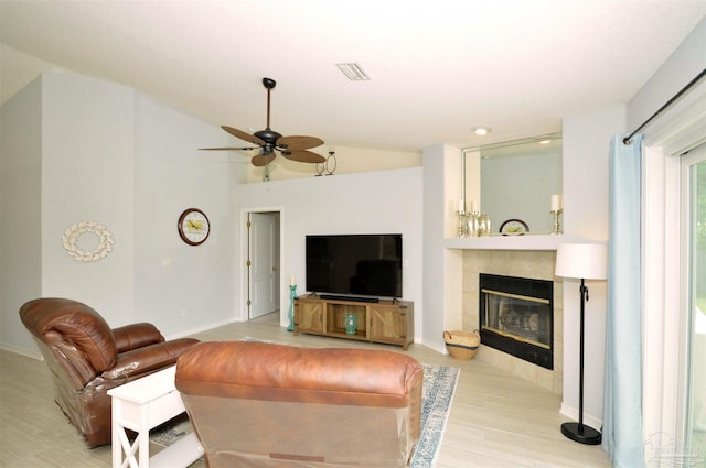 5735 Farrel Way, Milton, FL 32583 - living room featuring ceiling fan, light wood-style flooring, a fireplace, baseboards, and lofted ceiling