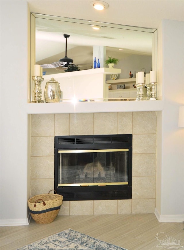 5735 Farrel Way, Milton, FL 32583 - detailed view of a tiled fireplace, wood finished floors, baseboards, and recessed lighting