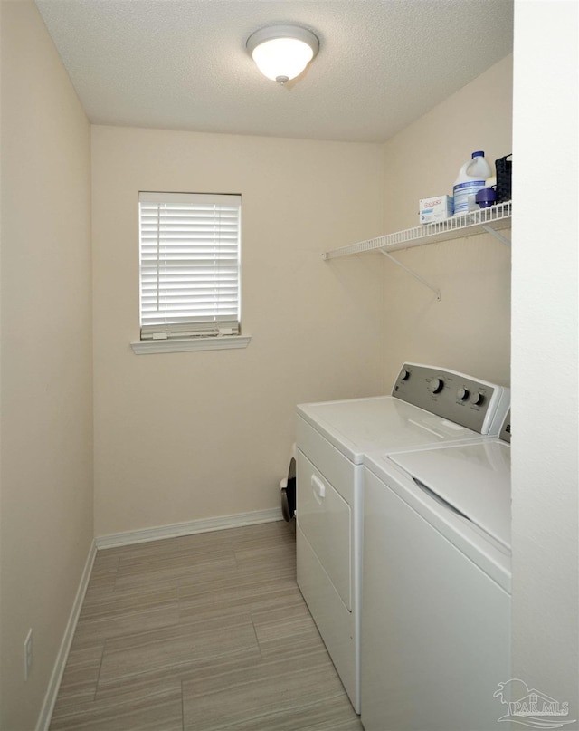 5735 Farrel Way, Milton, FL 32583 - washroom featuring separate washer and dryer, baseboards, and a textured ceiling