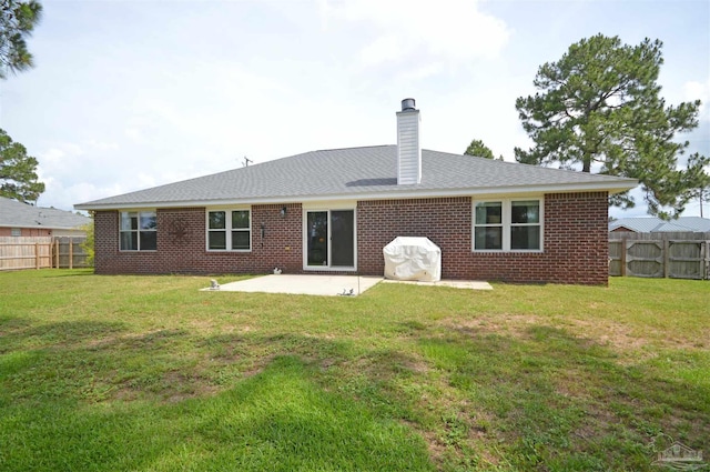 5735 Farrel Way, Milton, FL 32583 - back of property with a patio area, a chimney, and brick siding