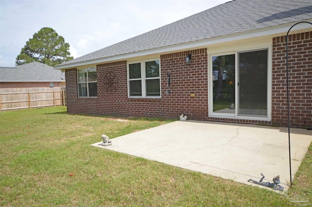 5735 Farrel Way, Milton, FL 32583 - rear view of property with brick siding, a shingled roof, and a patio