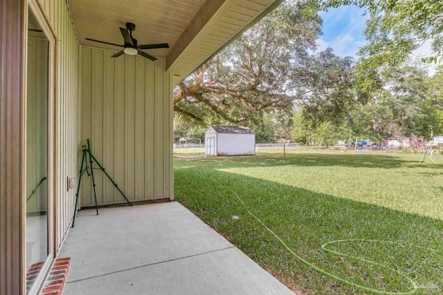 6115 Carroll Rd, Milton, FL 32583 - view of green lawn with a ceiling fan, a patio area, and view of wooded area