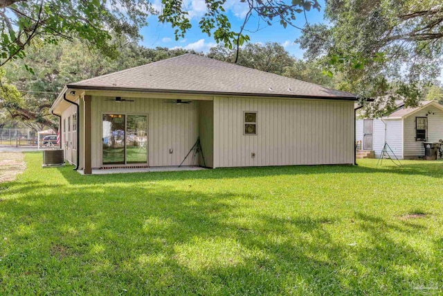6115 Carroll Rd, Milton, FL 32583 - back of property with a ceiling fan, a yard, roof with shingles, and central AC unit