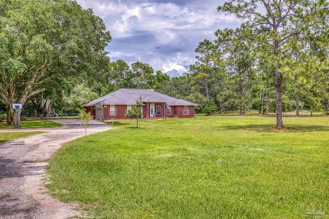 ranch-style house featuring a front yard, driveway, and brick siding
