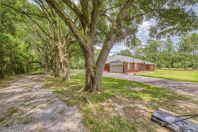 view of front of home with driveway, a front yard, and a garage