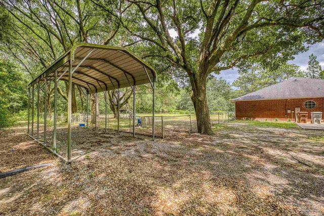view of yard with a detached carport and fence