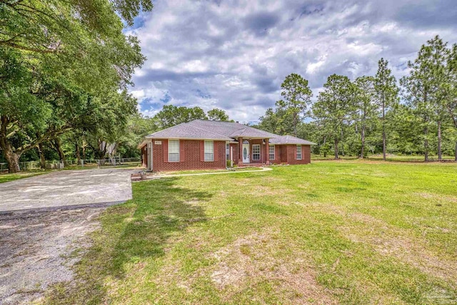 ranch-style home featuring concrete driveway, a front yard, and brick siding