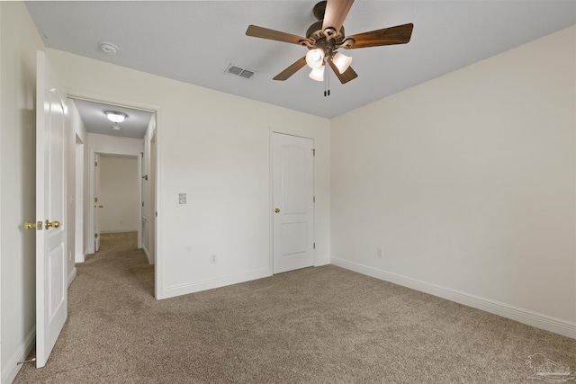 unfurnished bedroom featuring carpet floors, baseboards, and a ceiling fan