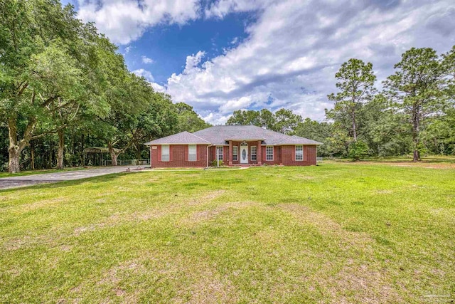 single story home featuring a front yard and brick siding