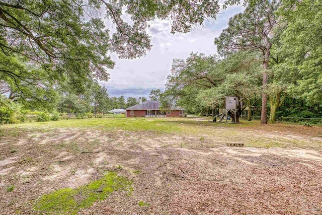 view of yard with a playground and fence