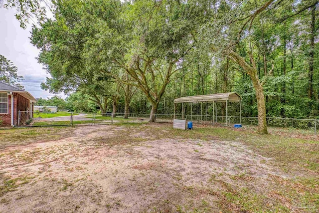 view of yard featuring a detached carport and fence