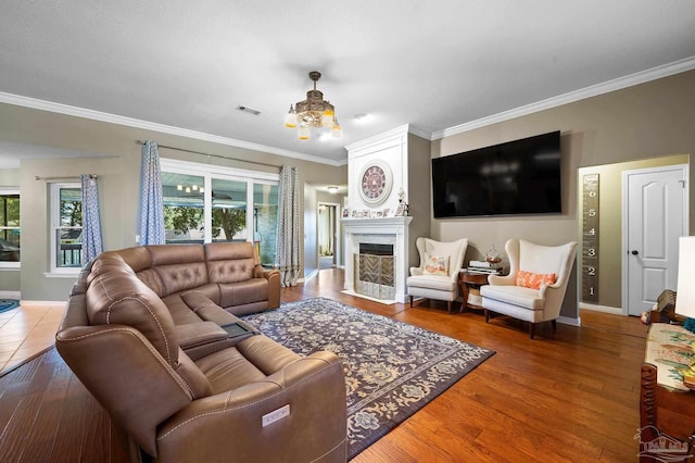 living room featuring crown molding, a high end fireplace, and hardwood / wood-style flooring