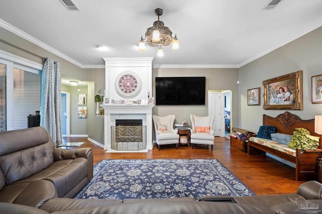 living room with dark hardwood / wood-style floors, a chandelier, and crown molding