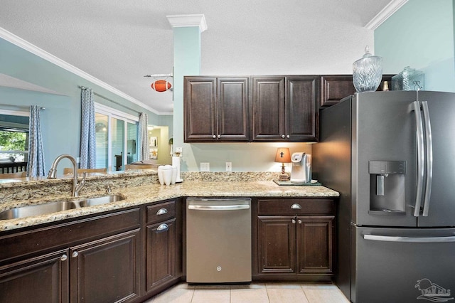 kitchen with sink, appliances with stainless steel finishes, dark brown cabinetry, light tile patterned floors, and ornamental molding