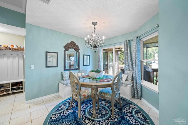 dining space with light tile patterned flooring, a notable chandelier, and a textured ceiling