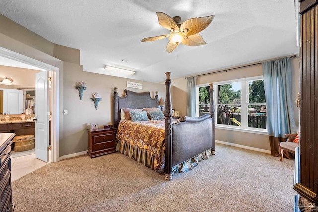 carpeted bedroom featuring ceiling fan, a textured ceiling, and ensuite bathroom