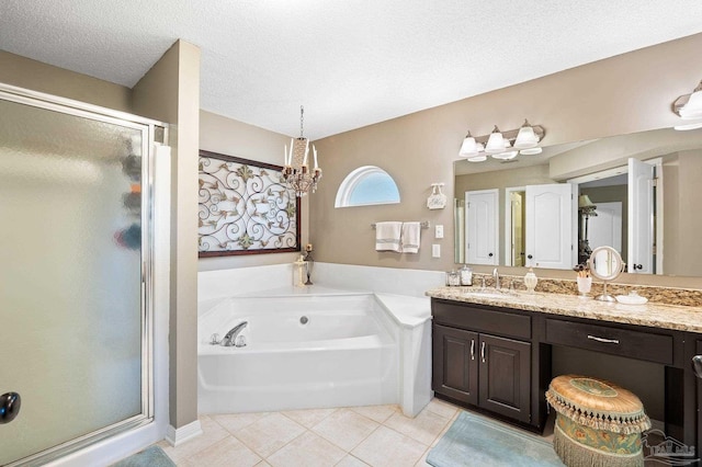 bathroom featuring tile patterned floors, a textured ceiling, vanity, and separate shower and tub