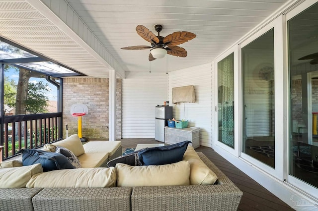 sunroom / solarium featuring ceiling fan