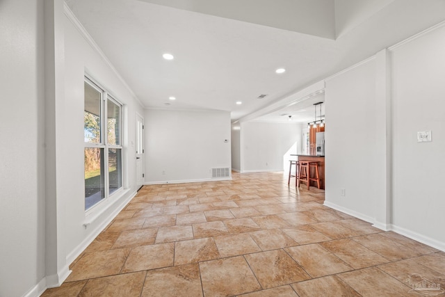 spare room featuring recessed lighting, visible vents, crown molding, and baseboards