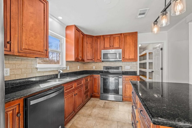 kitchen with visible vents, stainless steel appliances, a sink, and ornamental molding