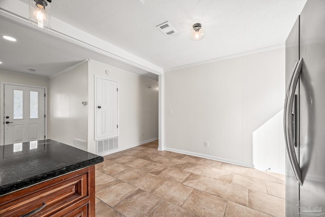 kitchen with visible vents, freestanding refrigerator, and crown molding