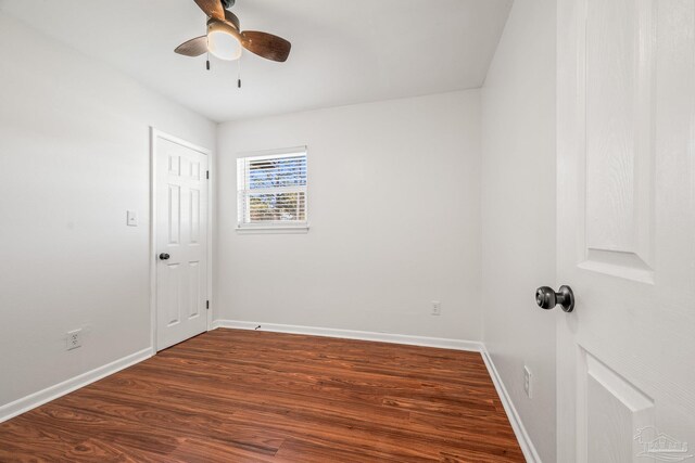 unfurnished room featuring ceiling fan, baseboards, and dark wood-style flooring