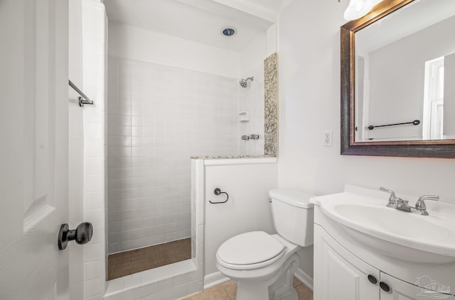 bathroom featuring a walk in shower, vanity, toilet, and tile patterned floors