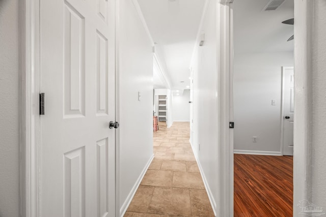 corridor featuring visible vents and baseboards