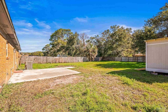 view of yard featuring a patio area, a fenced backyard, and central AC unit