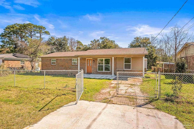 ranch-style home with a fenced front yard, brick siding, and a front lawn