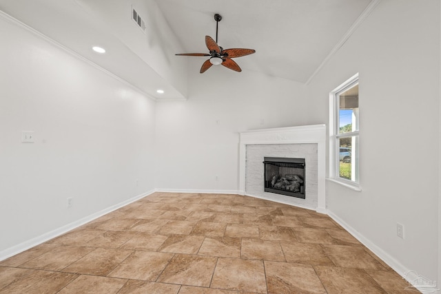 unfurnished living room with lofted ceiling, a fireplace, visible vents, baseboards, and ornamental molding