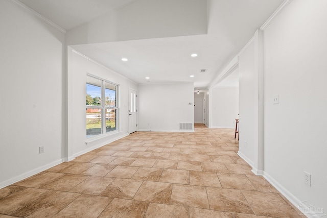 empty room featuring ornamental molding, visible vents, and baseboards