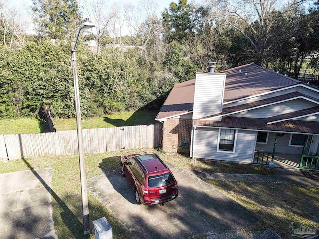 exterior space with fence and a chimney