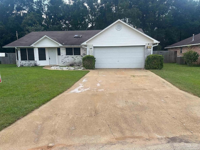 single story home featuring brick siding, concrete driveway, a front lawn, and fence