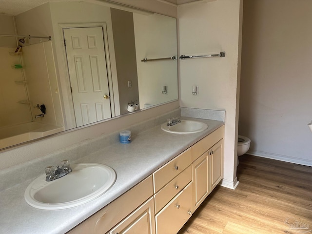 bathroom featuring hardwood / wood-style floors, vanity, and toilet