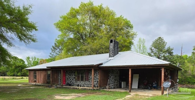4940 Dawson Rd, Century, FL 32535 - back of property featuring a chimney and metal roof