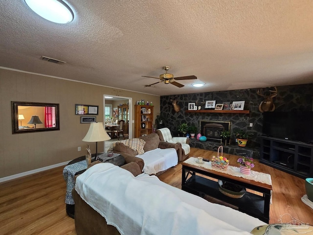 4940 Dawson Rd, Century, FL 32535 - living area featuring baseboards, a textured ceiling, visible vents, ceiling fan, and wood finished floors