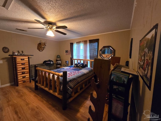4940 Dawson Rd, Century, FL 32535 - bedroom with visible vents, a textured ceiling, crown molding, and wood finished floors